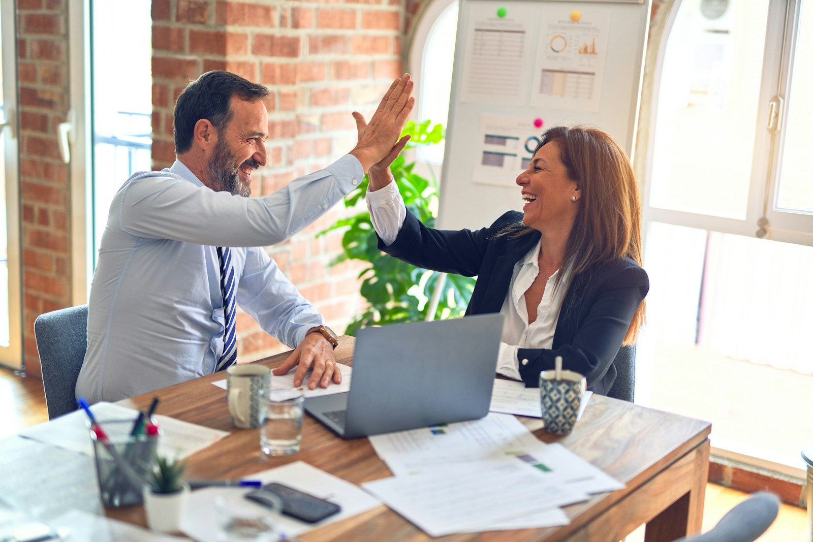 A recruitment consultant meeting a candidate across a table in a bright modern office